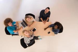 Multiethnic startup business team on meeting  top view photo