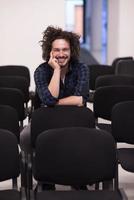 A student sits alone  in a classroom photo