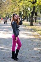 brunette Cute young woman posing outdoors photo