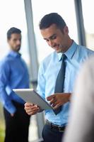 business man using tablet compuer at office photo