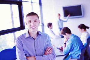 business man  on a meeting in offce with colleagues in background photo