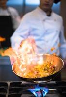 Chef doing flambe on food photo