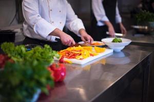 Chef cutting fresh and delicious vegetables photo