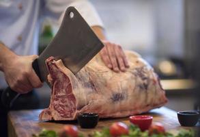 chef cutting big piece of beef photo