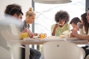 multiethnic group of happy friends lunch time photo