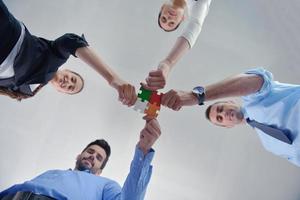 Group of business people assembling jigsaw puzzle photo