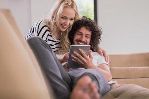 couple relaxing at  home with tablet computers photo