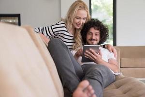 couple relaxing at  home with tablet computers photo