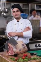 chef cutting big piece of beef photo