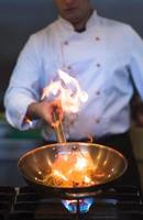 Chef doing flambe on food photo