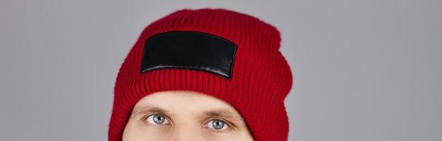 hipster in red winter hat isolated on grey background, blank,empty - cropped image photo