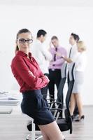 business woman standing with her staff in background photo