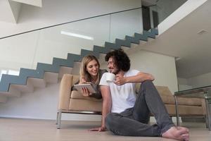 couple relaxing at  home with tablet computers photo