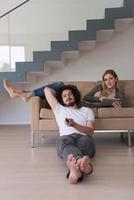 young couple relaxes in the living room photo