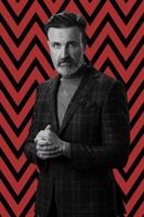 Black and white portrait of a stylish elegant senior businessman with a beard and casual business clothes against retro colorful pattern design background gesturing with hands photo