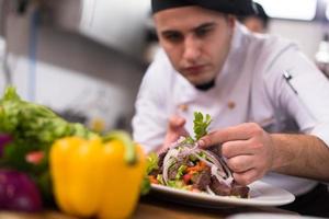 cook chef decorating garnishing prepared meal photo