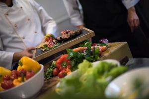 team cooks and chefs preparing meal photo