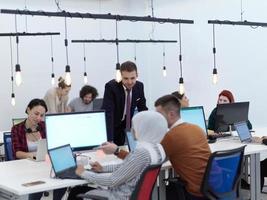 creative business people group as freelancers in modern coworking open space office photo