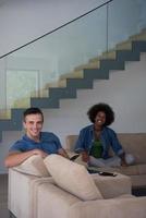 multiethnic couple relaxing at  home with tablet computers photo