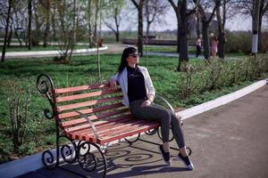 Beautiful young girl with black hair, sunglasses. Youth, happiness, summer sunny day, portrait photo