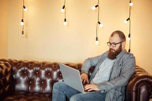 a successful man makes online transactions with the Bank on a laptop photo