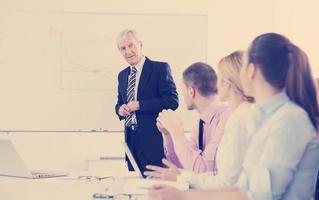 Senior business man giving a presentation photo