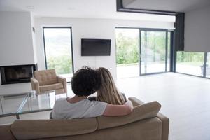 Rear view of couple watching television photo