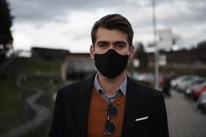 business man wearing protective face mask at luxury office photo