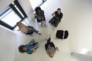 Multiethnic startup business team on meeting  top view photo