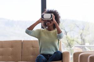 black woman using VR headset glasses of virtual reality photo