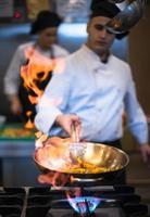 Chef doing flambe on food photo