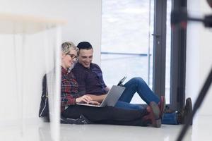 startup business, couple working on laptop computer at office photo