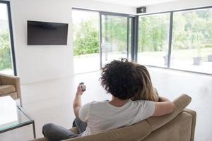Rear view of couple watching television photo