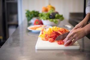 Chef cutting fresh and delicious vegetables photo