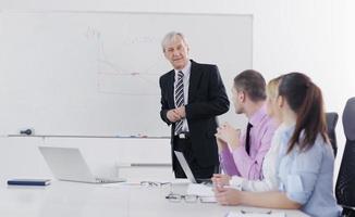 Senior business man giving a presentation photo