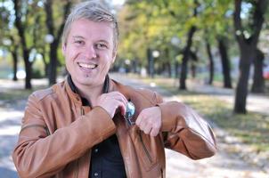 Handsome young man smiling outdoors photo