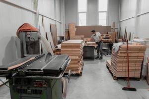 Rear view of a man wearing a face mask due to a coronavirus pandemic and working with a CNC milling machine. photo