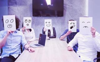startup business team holding a white paper over face photo