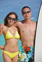 happy young  couple enjoying summer on beach photo