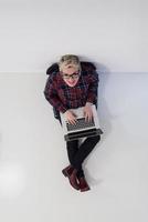 top view of young business woman working on laptop computer photo