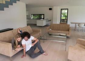 couple relaxing at  home with tablet computers photo