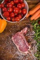 top view of raw steak on wooden table photo