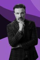 Black and white portrait of a stylish elegant senior businessman with a beard and casual business clothes against retro colorful pattern design background gesturing with hands photo