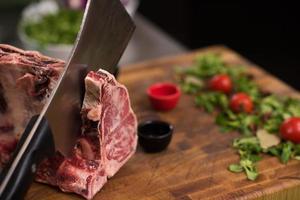 chef cutting big piece of beef photo