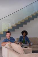 multiethnic couple relaxing at  home with tablet computers photo