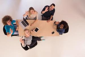 Multiethnic startup business team on meeting  top view photo