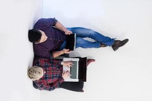 top view of  couple working on laptop computer at startup office photo