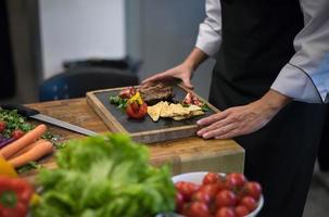 female Chef preparing beef steak photo