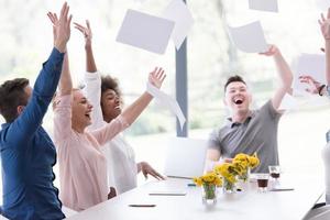 multiethnic startup Group of young business people throwing documents photo