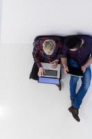 top view of  couple working on laptop computer at startup office photo